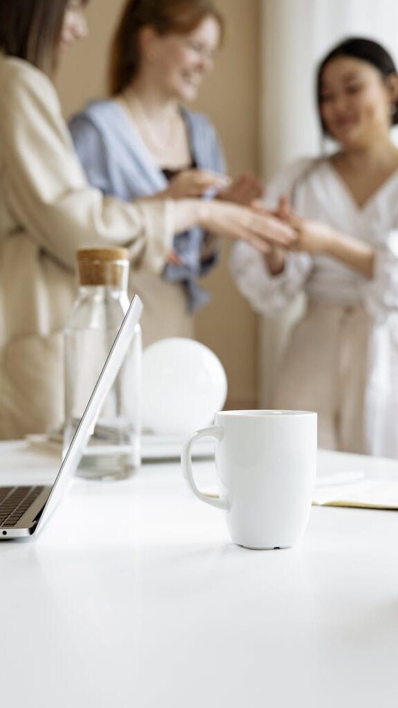 A Laptop on the Table Near the Ceramic Mug