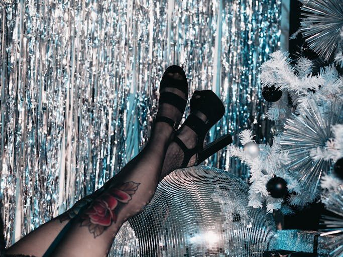 Woman in High Heels Resting Her Legs on a Disco Ball